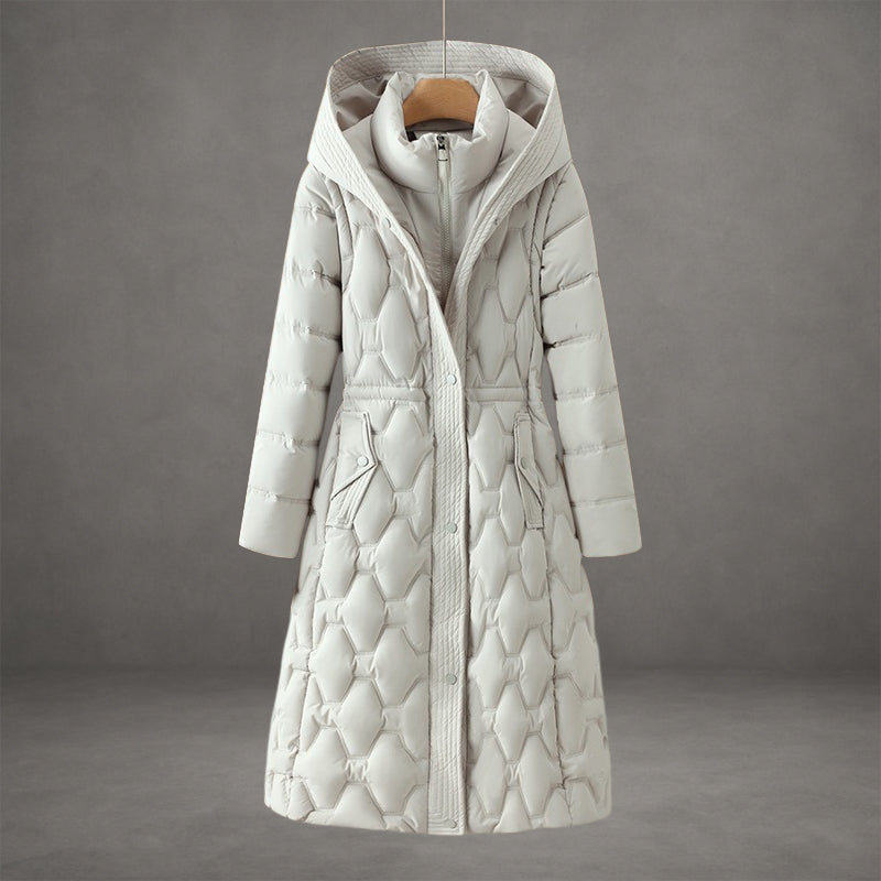 Elegant off-white coat with textured quilted pattern and hood in a studio setting.