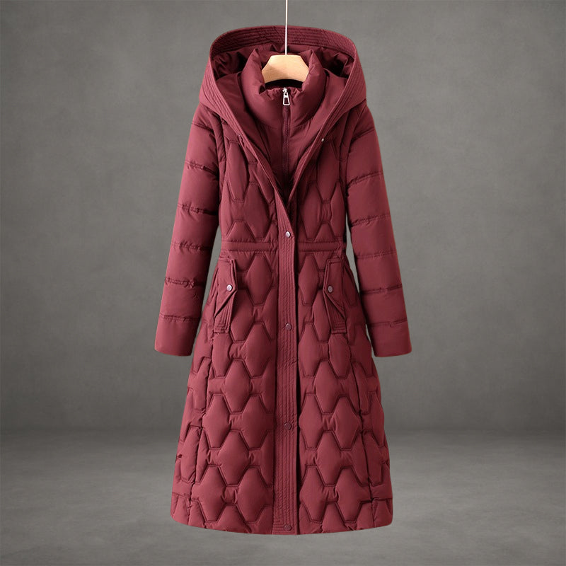 Elegant maroon coat with textured quilted pattern and hood in a studio setting.