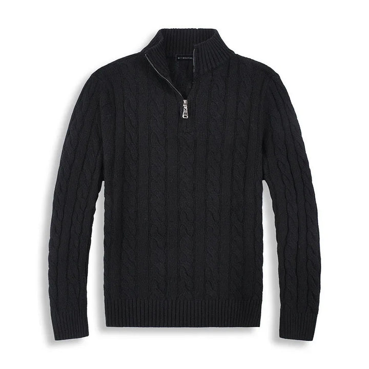 Black cable-knit sweater with half-zip design, laid flat against a white background in a studio setting.