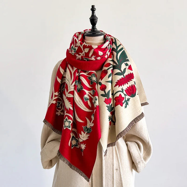 Red and cream scarf with intricate botanical design on a mannequin.