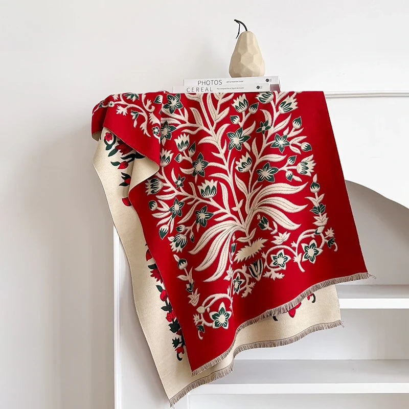 Red botanical scarf with floral design draped over a white mantelpiece.
