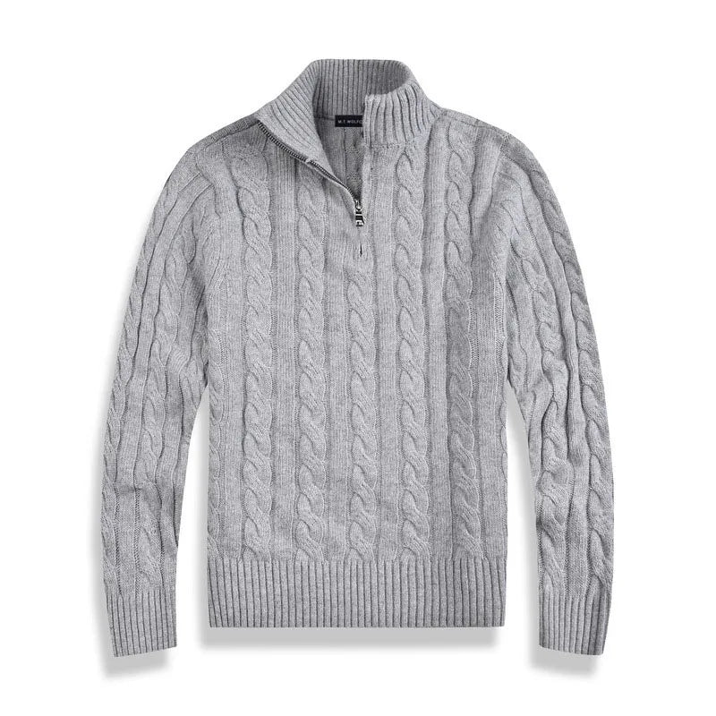 Gray cable-knit sweater with half-zip design, laid flat against a white background in a studio setting.