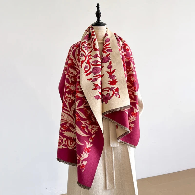 Red and cream botanical scarf on a mannequin against a plain background.