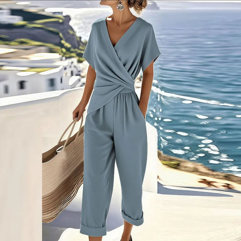 Stylish blue two-piece set with wrap top, capri pants, and large woven tote, by ocean and coastal architecture.