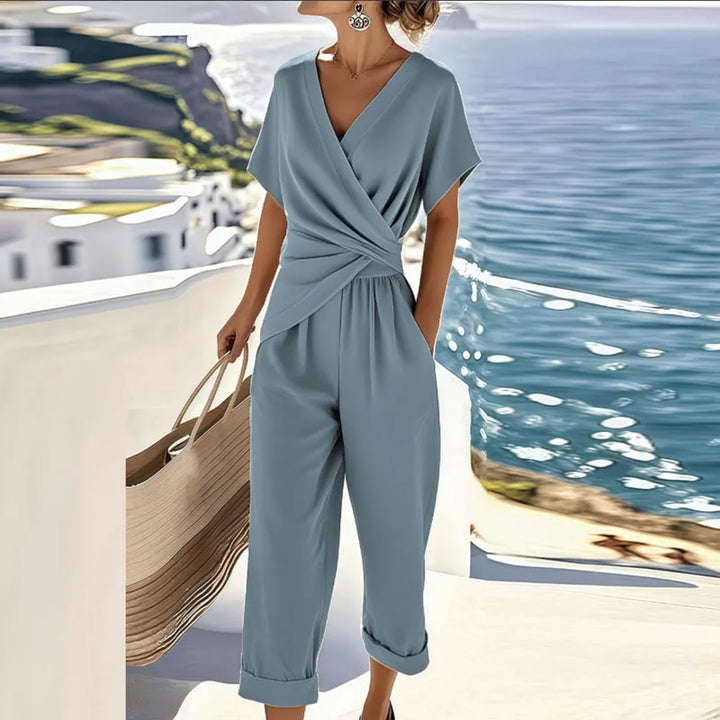 Stylish blue two-piece set with wrap top, capri pants, and large woven tote, by ocean and coastal architecture.