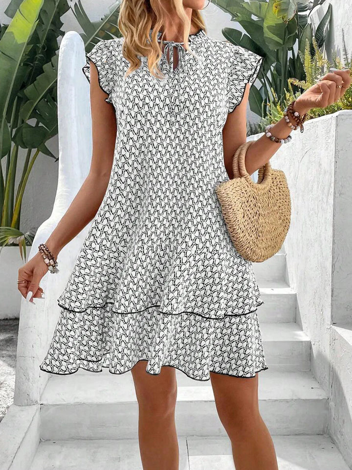 Krest – Printed Ruffle Mini Dress with Tie Neck