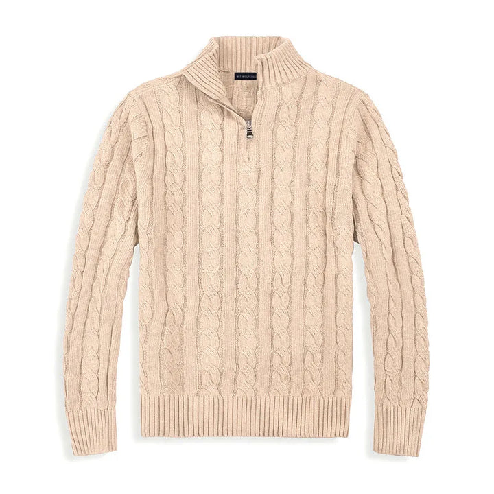 Beige cable-knit sweater with half-zip design, laid flat against a white background in a studio setting.