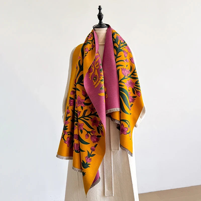 Colorful botanical scarf draped over a mannequin against a white wall.