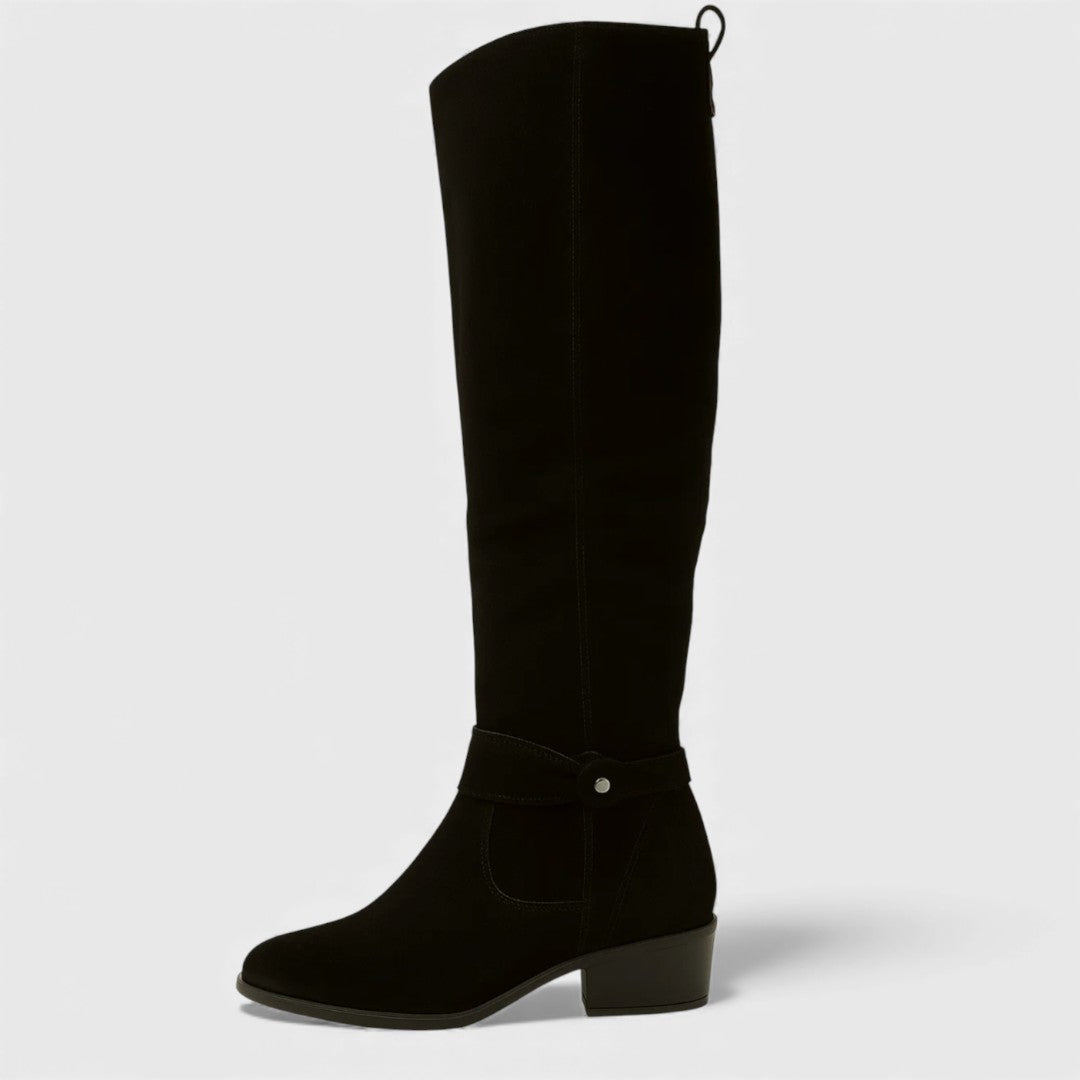 Single black knee-high boot with buckle detail and heel, studio background.