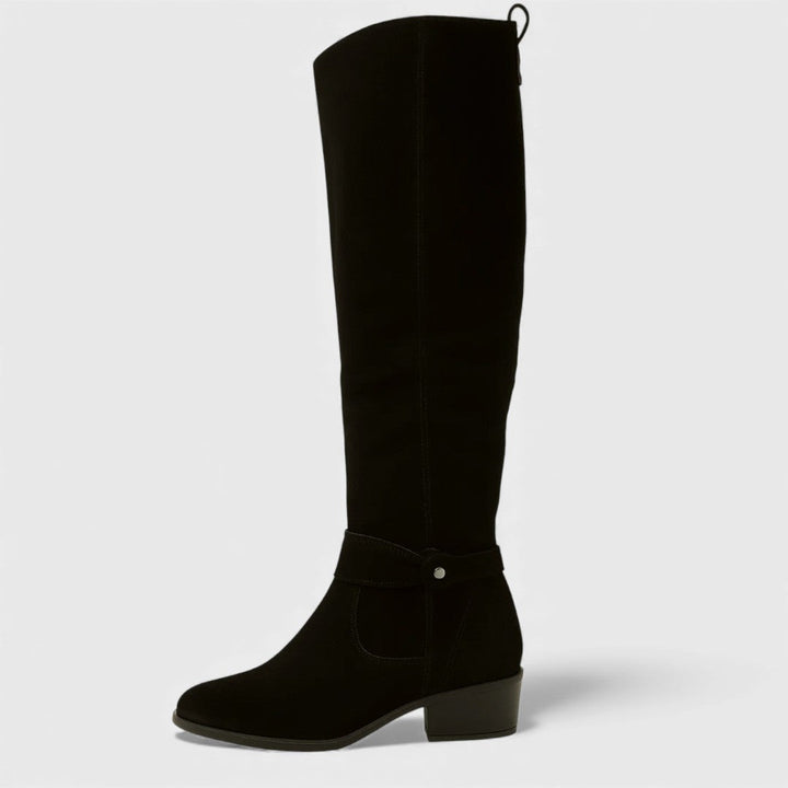 Single black knee-high boot with buckle detail and heel, studio background.