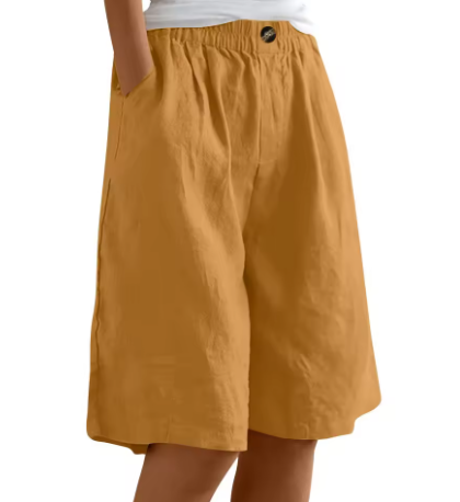 Mustard yellow comfort shorts with an elastic waist and pockets on a plain white background.