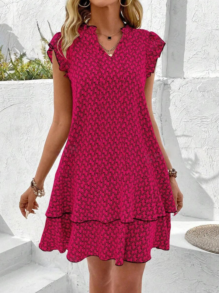 Krest – Printed Ruffle Mini Dress with Tie Neck