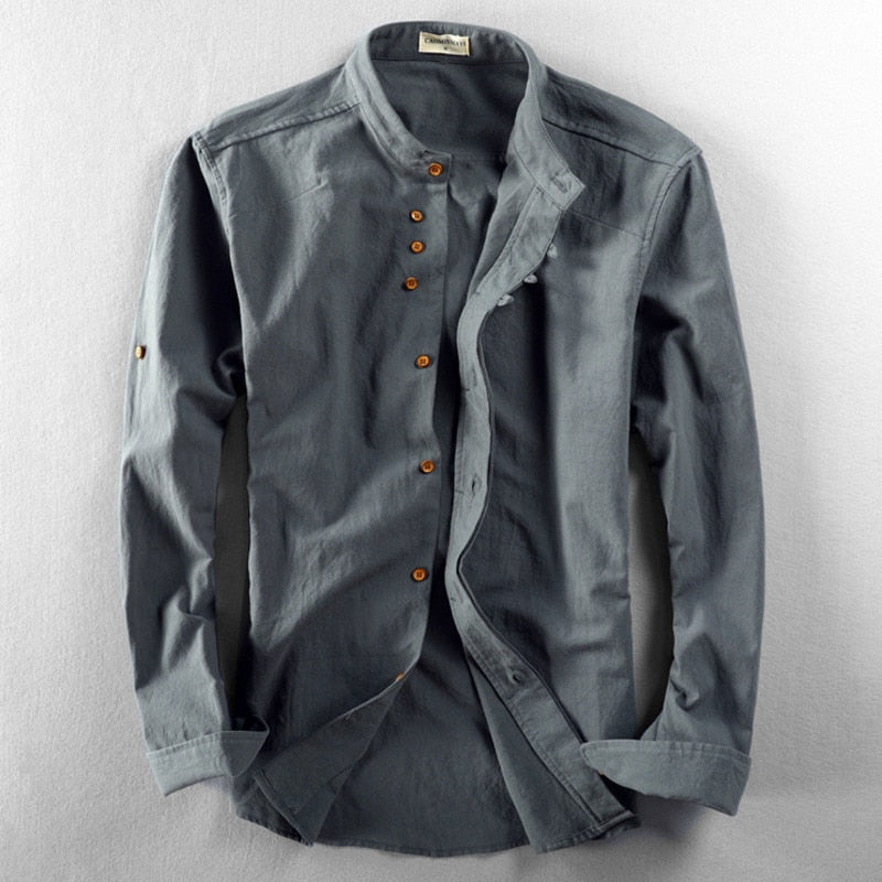 Gray long-sleeve shirt with a stand collar and brown buttons, displayed on a light gray studio background.