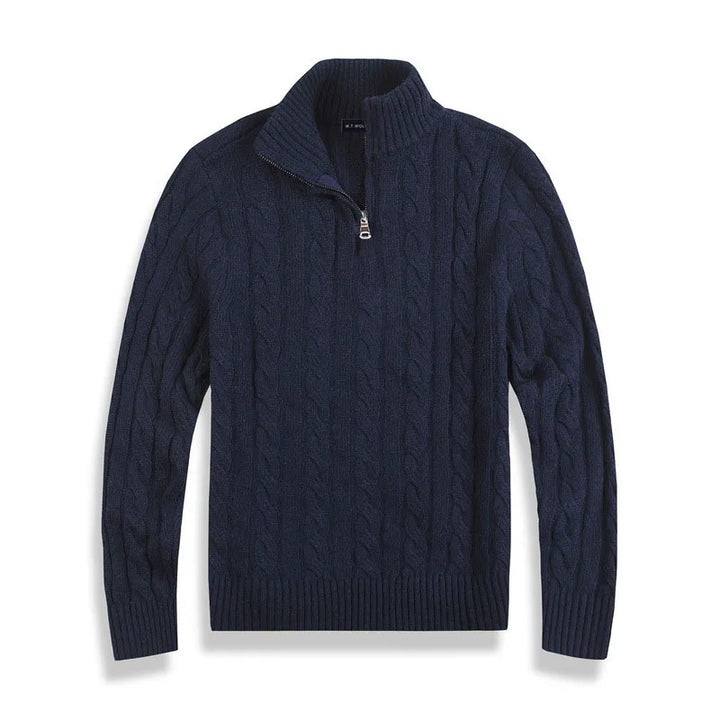 Navy cable-knit sweater with half-zip design, laid flat against a white background in a studio setting.