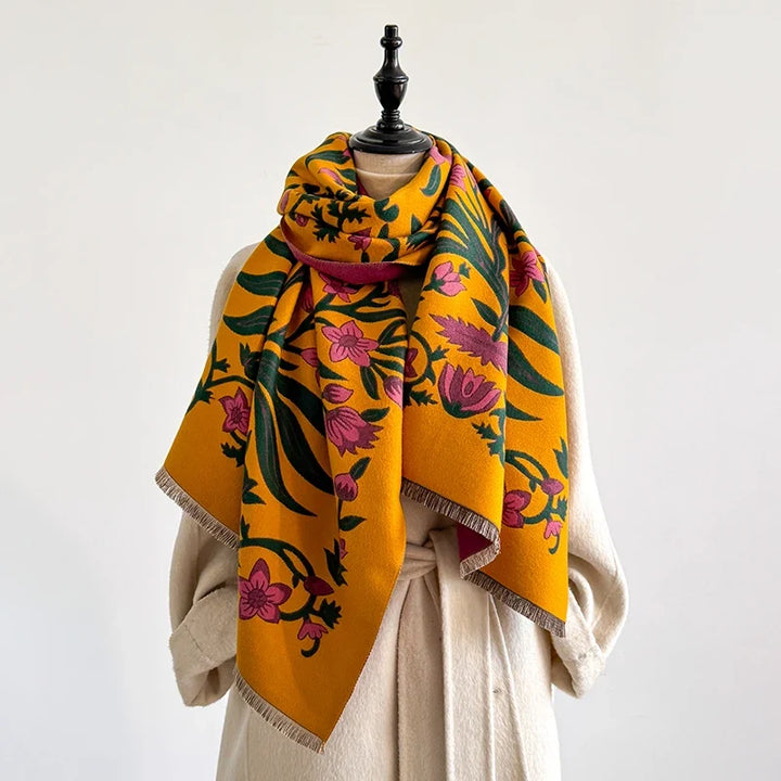 Colorful botanical scarf elegantly wrapped around a mannequin in a studio.