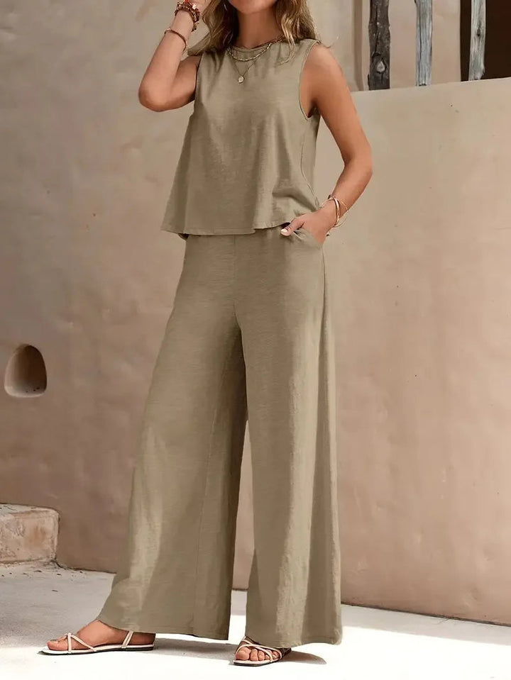 Beige sleeveless two-piece set with wide-leg pants, styled outdoors against a beige wall.