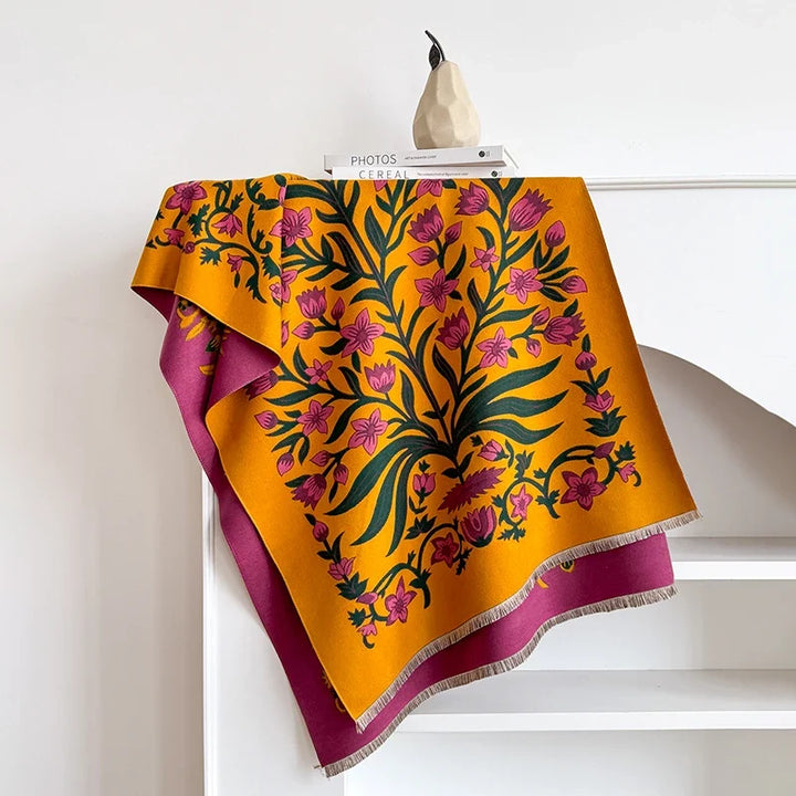 Botanical scarf with vibrant floral design draped over a white mantelpiece.