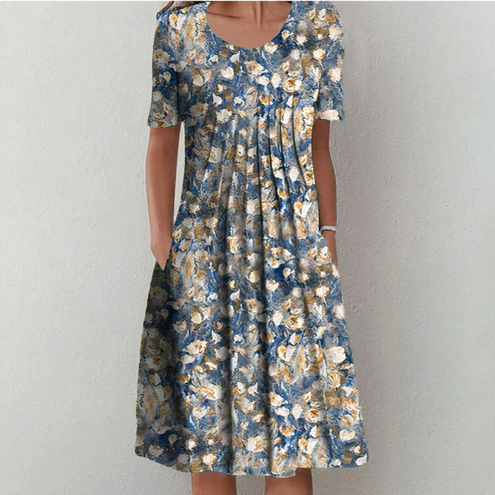 Blue and beige floral dress with an abstract pattern in a studio setting.