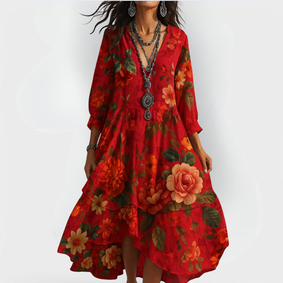 Model in a red vintage floral dress with bold flower patterns, standing against a light white backdrop.