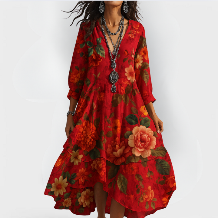 Model in a red vintage floral dress with bold flower patterns, standing against a light white backdrop.