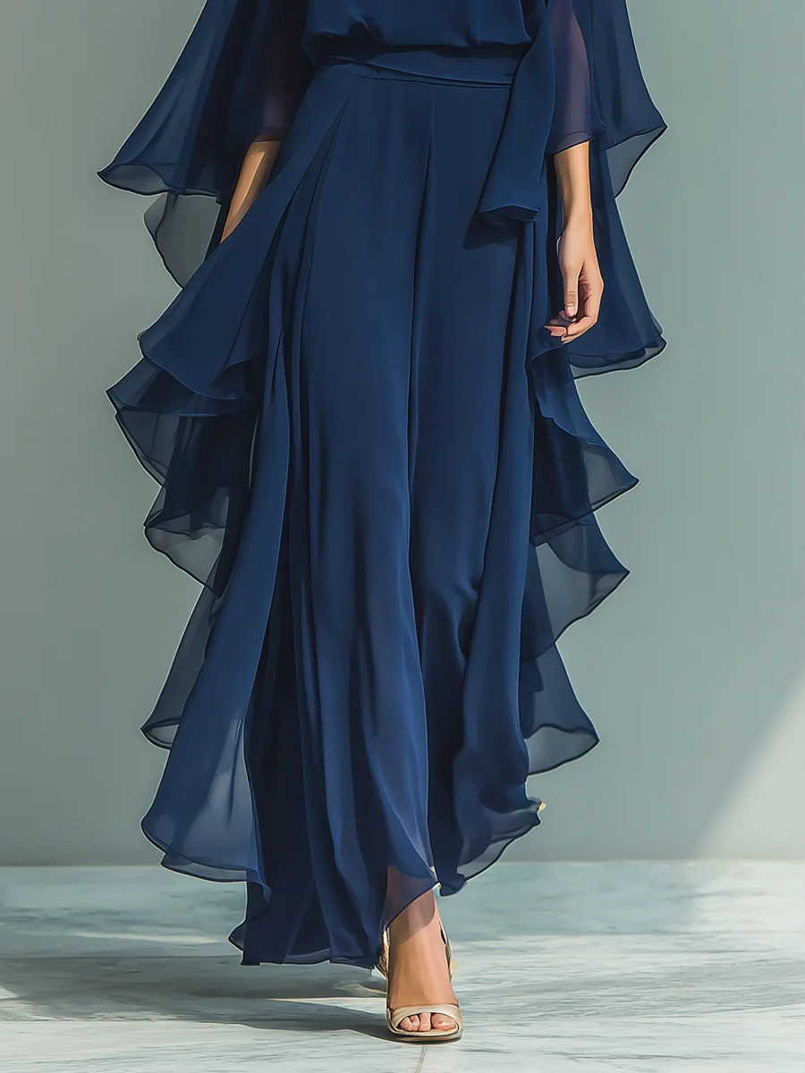 Close-up of deep blue layered skirt with elegant flows, paired with heels, studio background.
