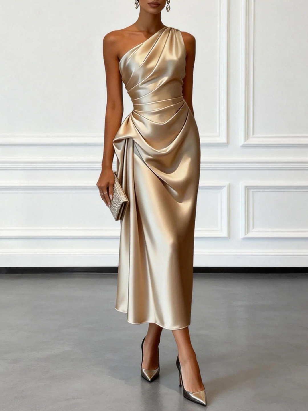 Elegant champagne one-shoulder midi dress with draped design in a minimalist indoor setting.