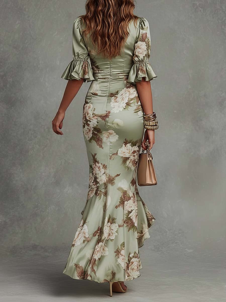 Rear view of a woman in a floral maxi dress showcasing puff sleeves and a fitted waist. Accessories include a handbag and sandals, set in a textured studio.