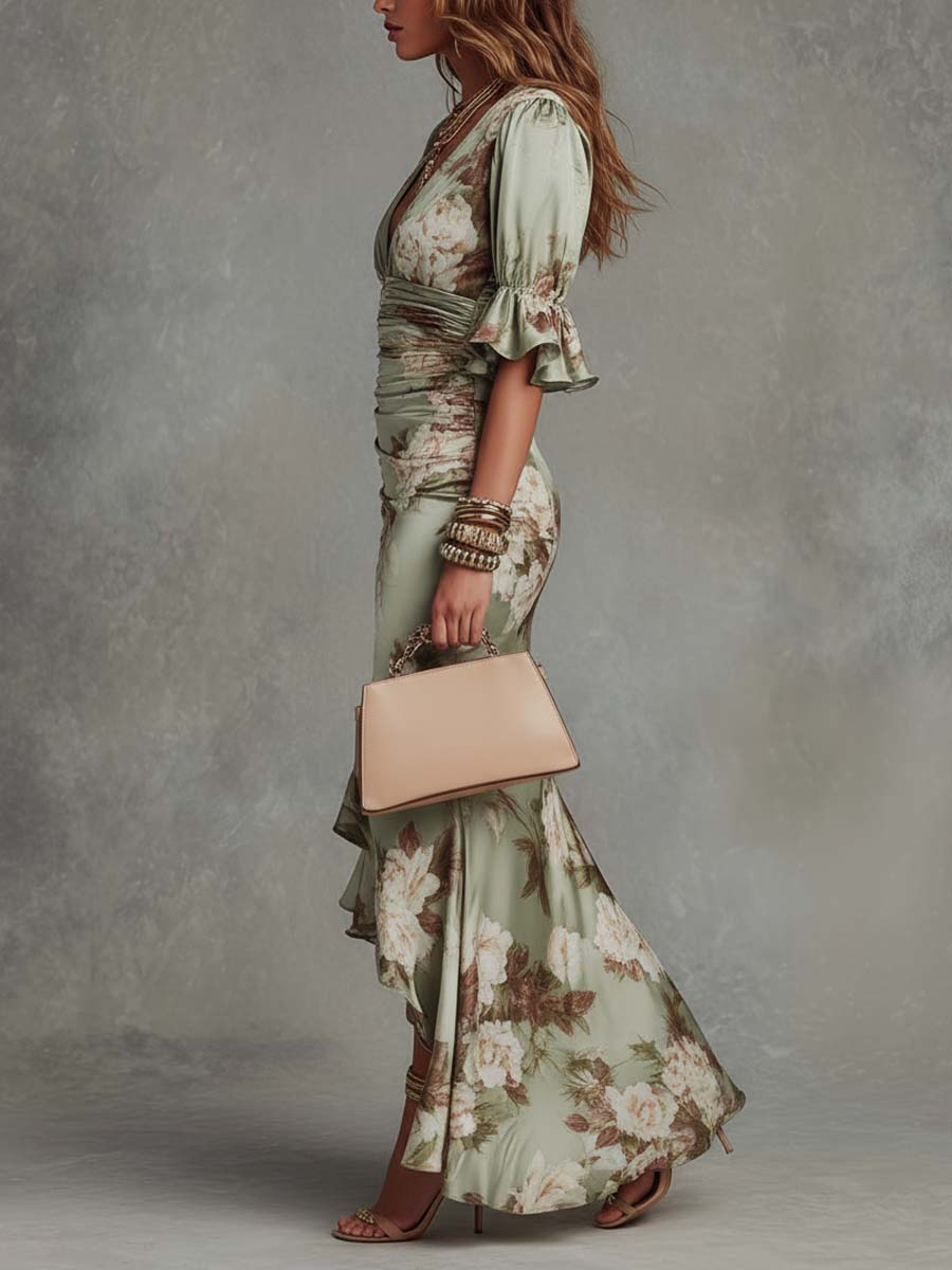 Side profile of a woman in a floral maxi dress with puff sleeves, holding a beige handbag. Worn with sandals, jewelry against a textured studio background.
