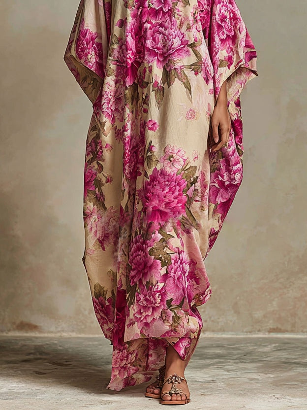 Lower half of maxi dress with pink floral pattern, hemline grazing floor, in neutral indoor setting with delicate textures.