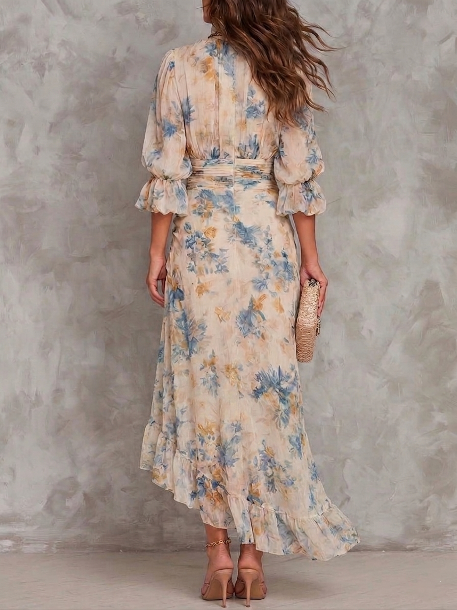 Back view of model wearing a floral maxi dress with ruffled sleeves, holding a clutch against a textured background.