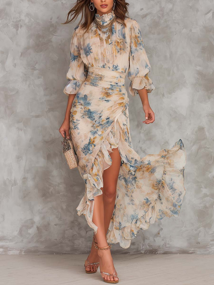 Model in flowing floral maxi dress with ruffled hem, walking against a textured gray studio background.