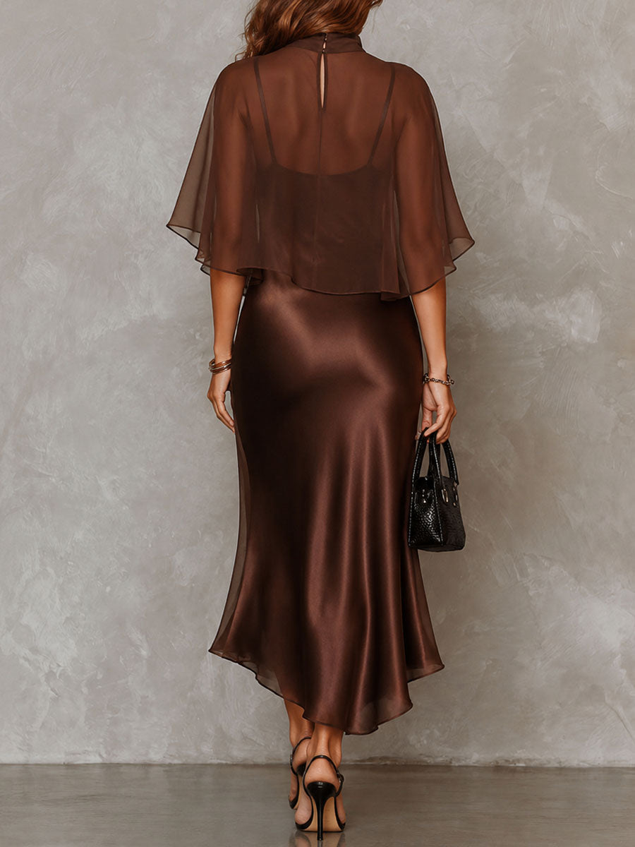 Back view of a brown midi dress with a sheer overlay. Studio background.
