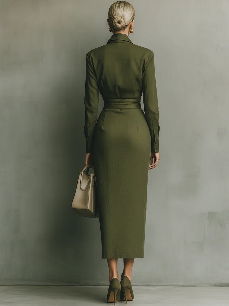 Back view of a woman in an olive green wrap maxi dress, carrying a taupe handbag, in a studio setting.