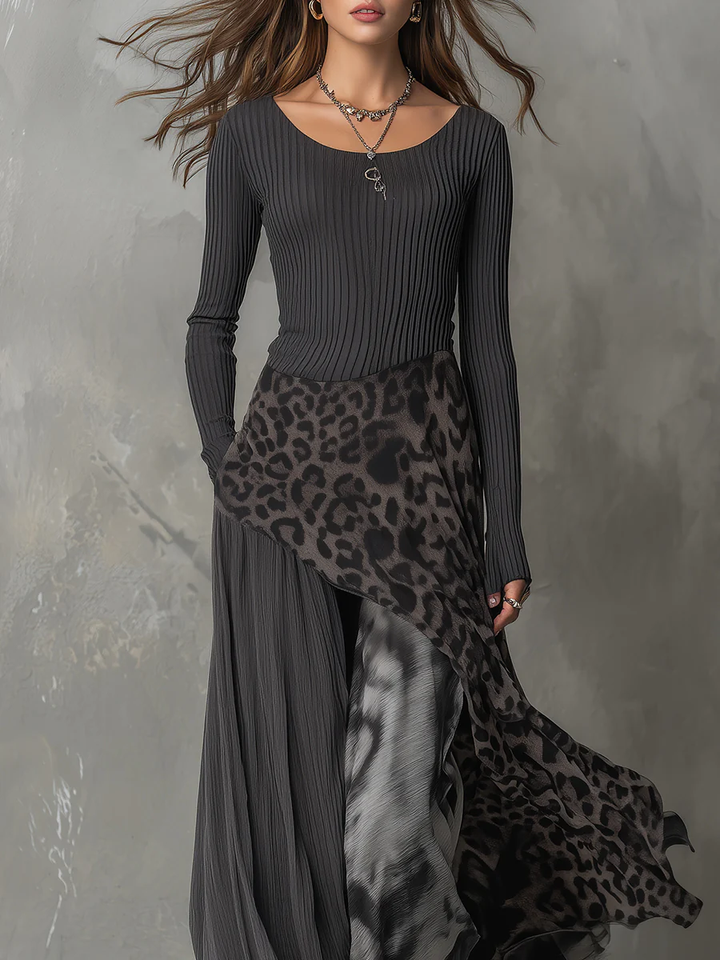 Close-up of gray maxi dress with animal print detail, elegant design, worn by model in studio.