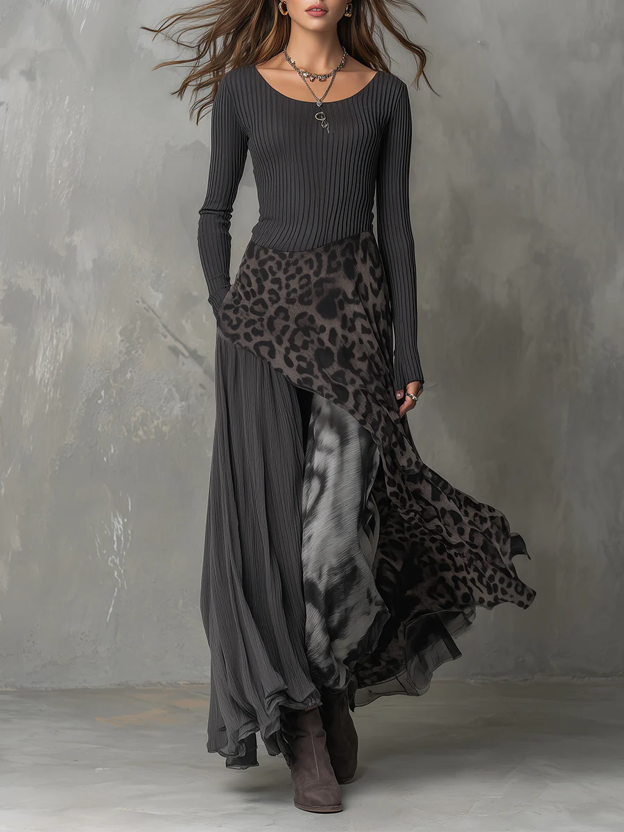 Elegant gray maxi dress with animal print detail, flowing design, model in studio setting.