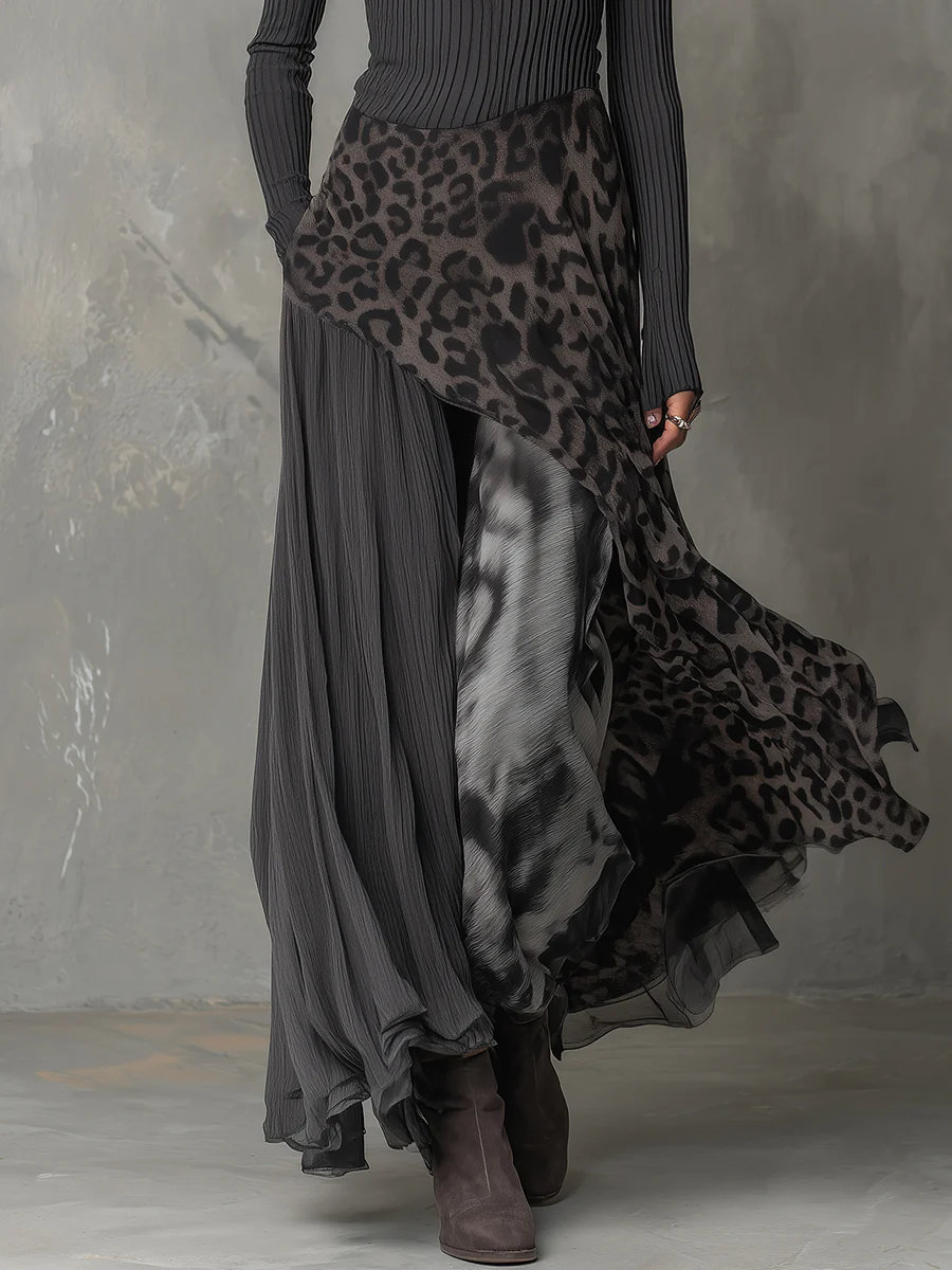 Gray maxi dress with animal print details, flowing layered design, shown in studio.