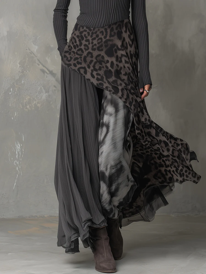 Gray maxi dress with animal print details, flowing layered design, shown in studio.