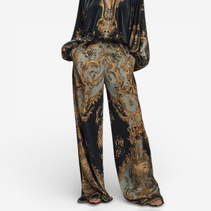 Lower half view of the elegant printed set with wide-leg pants in a detailed baroque pattern, set against a white background.