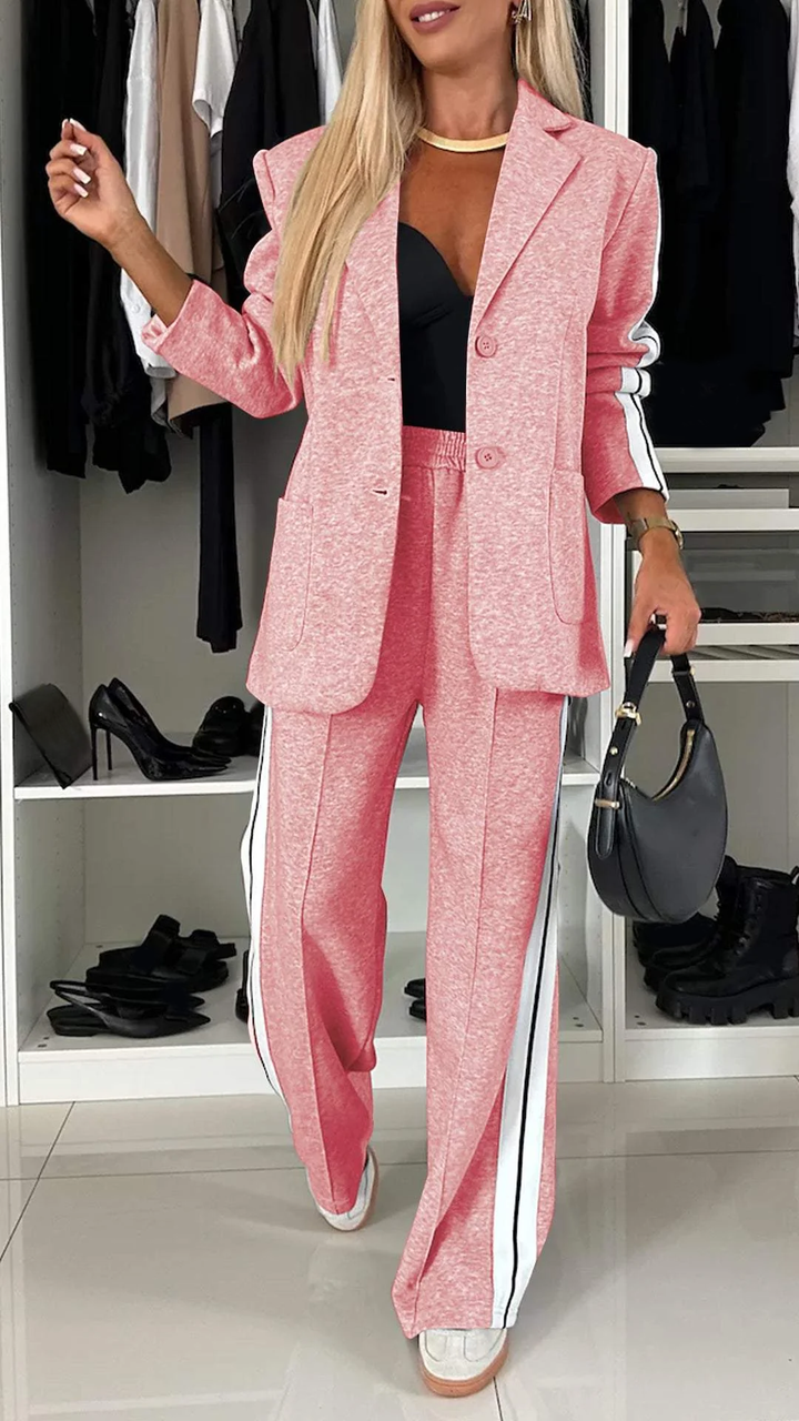 Pink casual office suit with white stripes, shown in a wardrobe space with footwear arranged neatly.