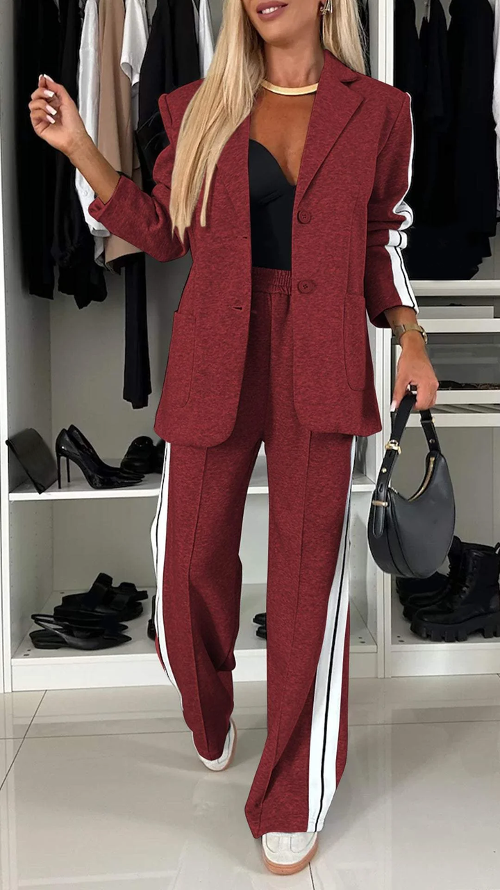 Red casual office suit with white stripes, displayed in a closet with black high heels.