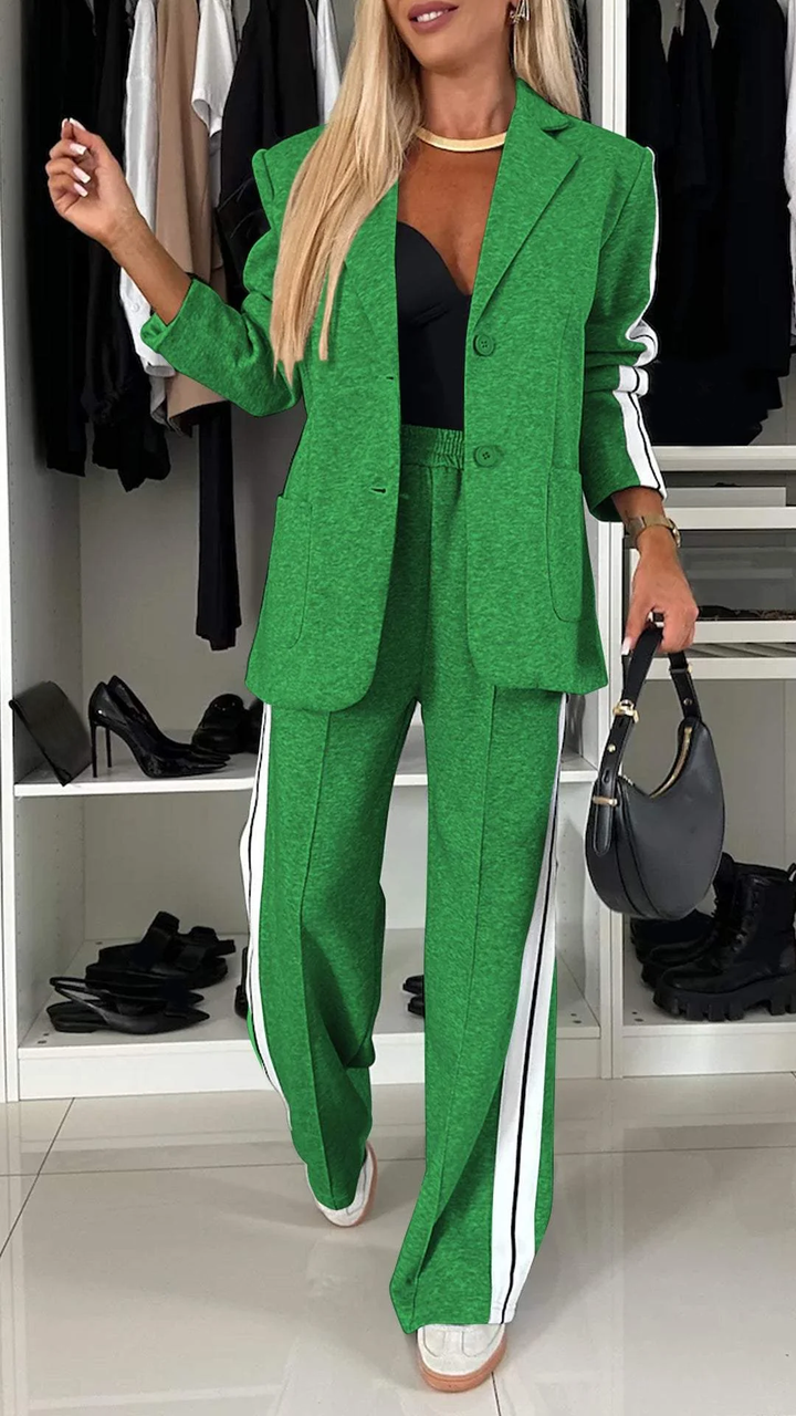 Green casual office suit with white stripes in wardrobe setting, showcasing shoes on shelves.