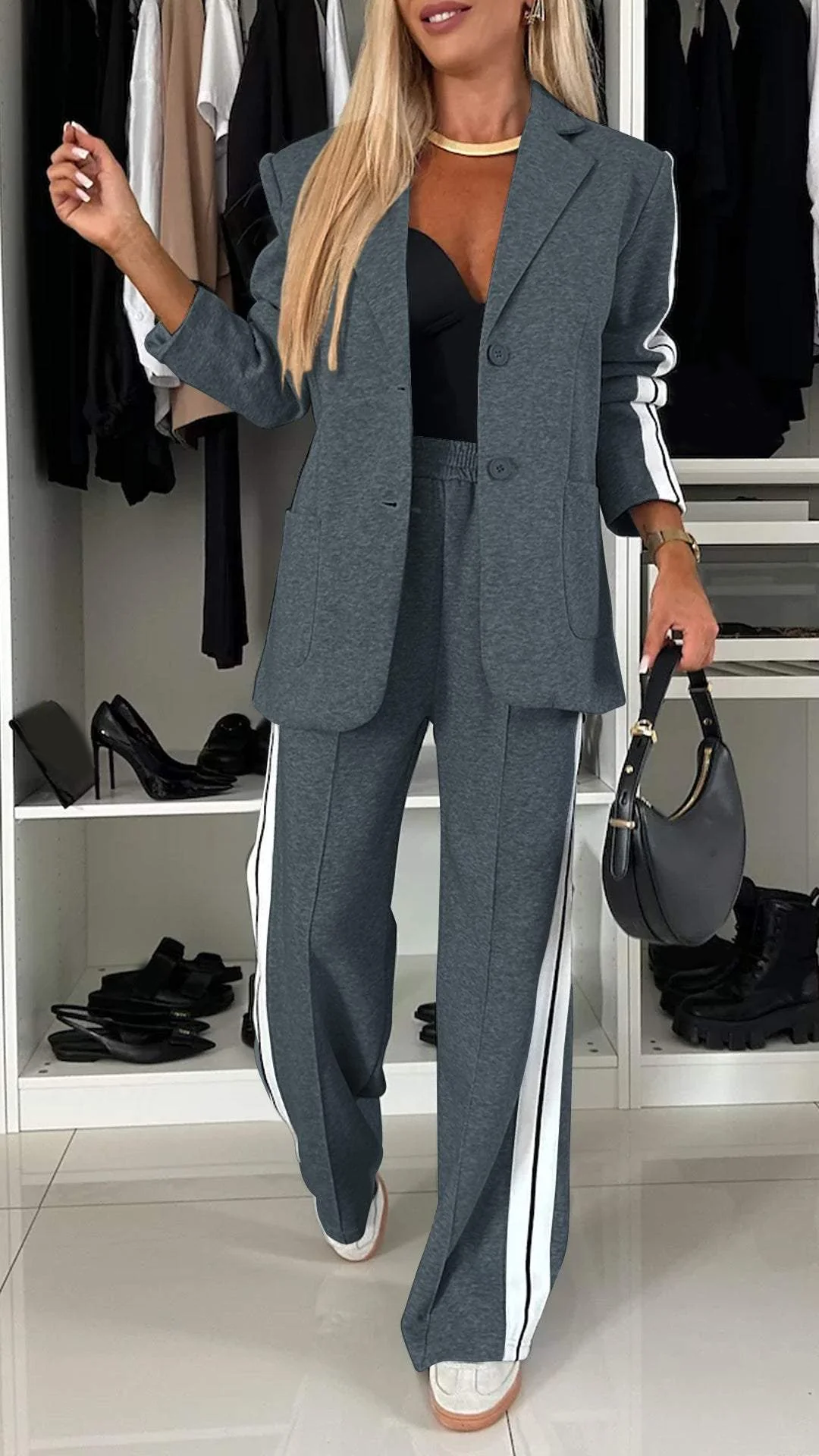 Dark grey casual office suit with white stripes, displayed in a closet with black high heels.