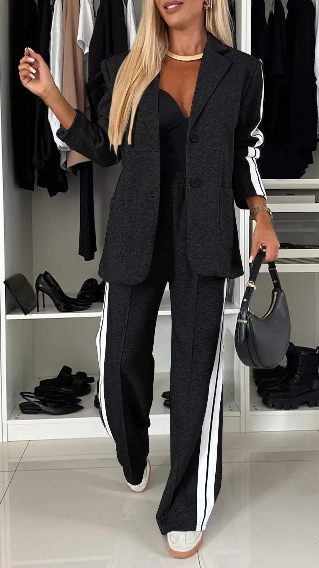 Black casual office suit with white stripes, showcased in a wardrobe setting with shelves of shoes.