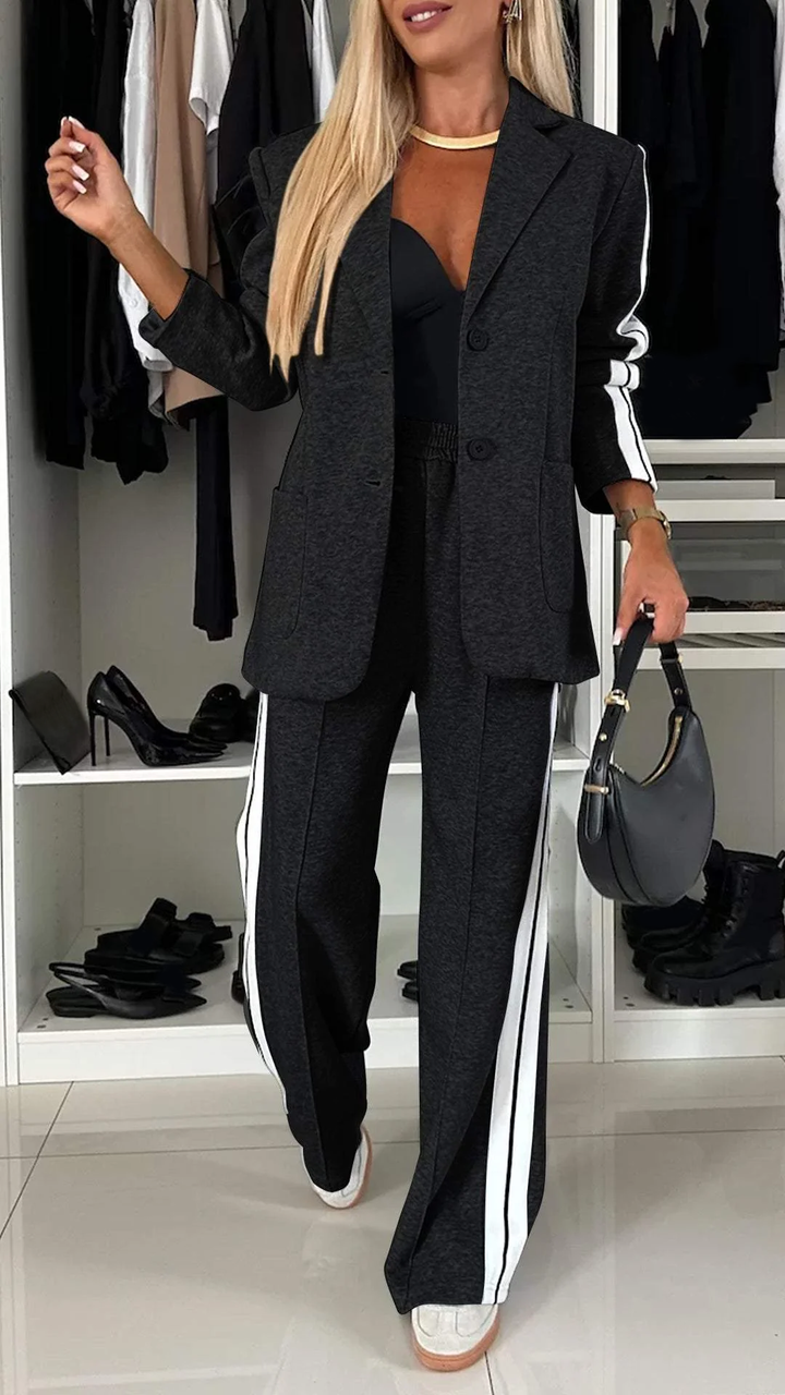 Black casual office suit with white stripes, showcased in a wardrobe setting with shelves of shoes.