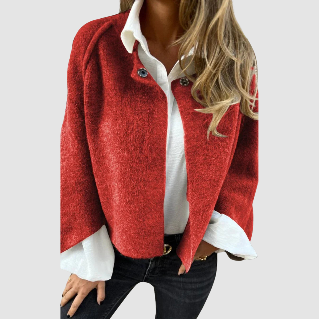 Soft, deep red spring coat over a white shirt on a person, worn with black jeans, studio background.