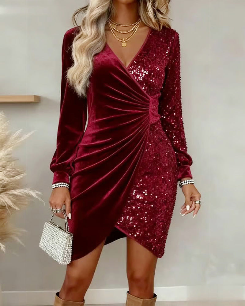 Red velvet sequin dress with ruched detail, accessorized with layered necklaces and a small embellished handbag in a modern indoor setting.
