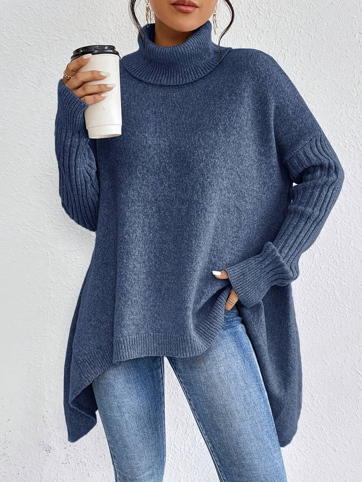 Blue sweater with turtleneck, long sleeves, and textured knit pattern. Worn with jeans, holding a coffee cup against a white background.