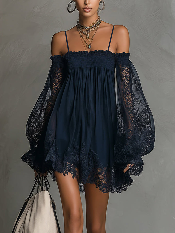 Navy off-shoulder dress with lace sleeves and hem, worn with layered necklaces, in studio setting.