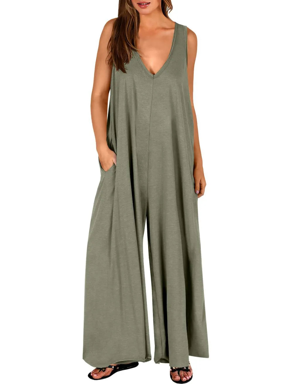 Olive green V-neck jumpsuit with wide legs, modeled in a studio with a white background.