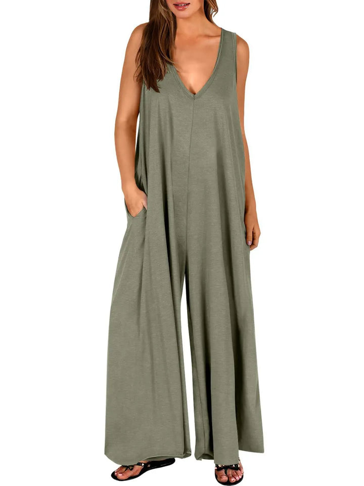 Olive green V-neck jumpsuit with wide legs, modeled in a studio with a white background.